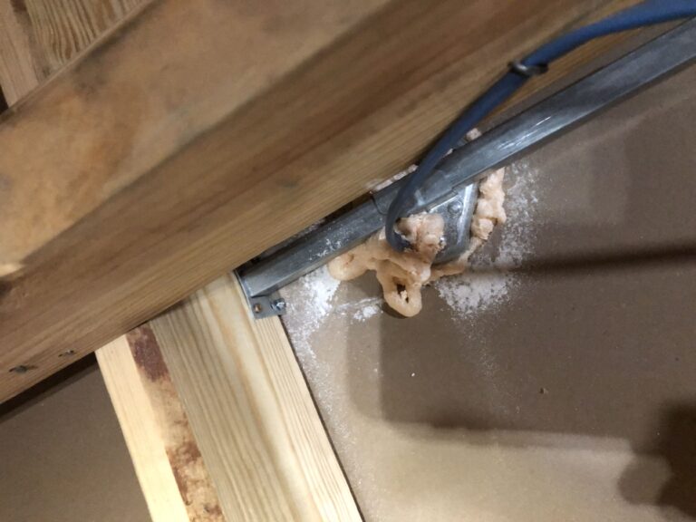 Sealed opening beside attic framing