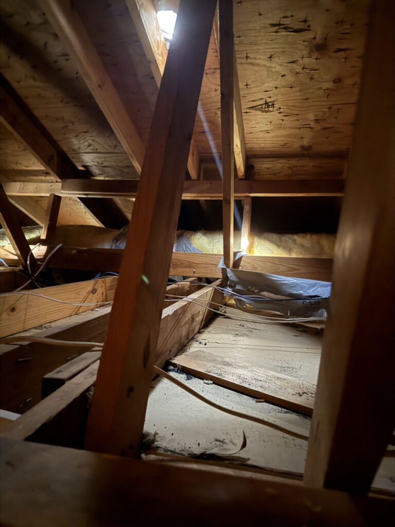 Exposed attic framing and floor during preparation