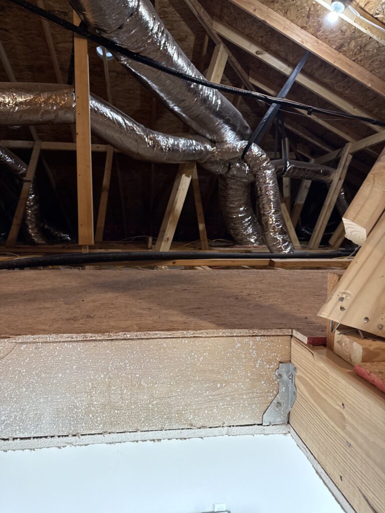Exposed attic framing and floor during preparation