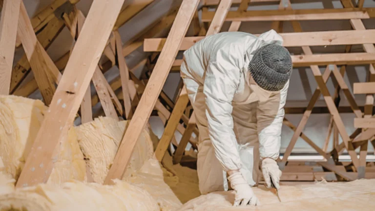 Technician working in an attic roof space
